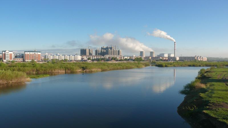 Industrial buildings and chimneys on the riverbanks in Inner Mongolia.