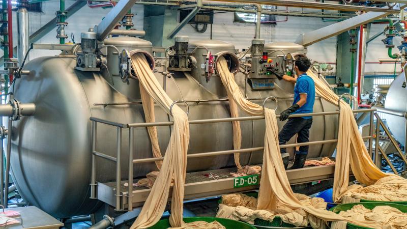 Textile dyeing process in a factory with vibrant colors in Bangladesh.