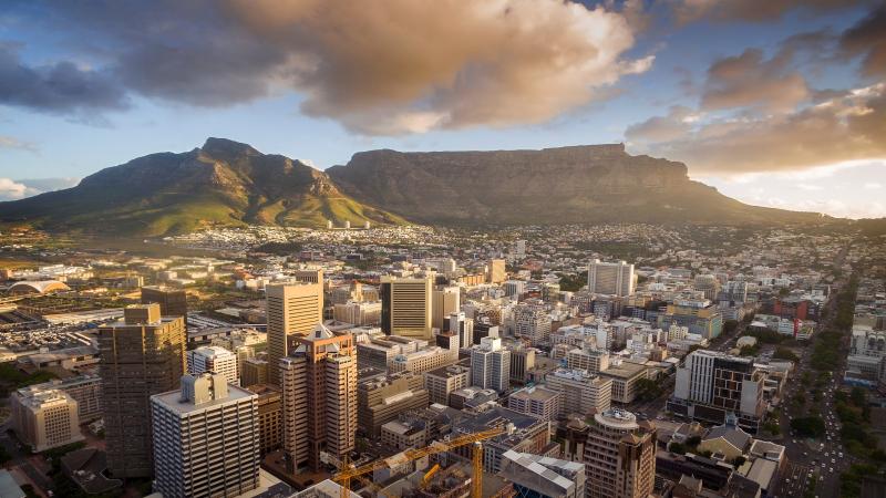 Aerial view of Cape Town CBD with Table Mountain at sunset.