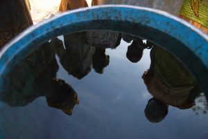 Reflection in water tank. Ghana. Photo: © Arne Hoel / World Bank